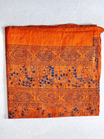 Rusty orange coloured cotton square scarf woven with sparkly lurex threads and a d. blue printed pattern