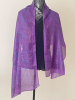 Dark purple printed scarf woven with sparkly lurex threads draped over a black top.